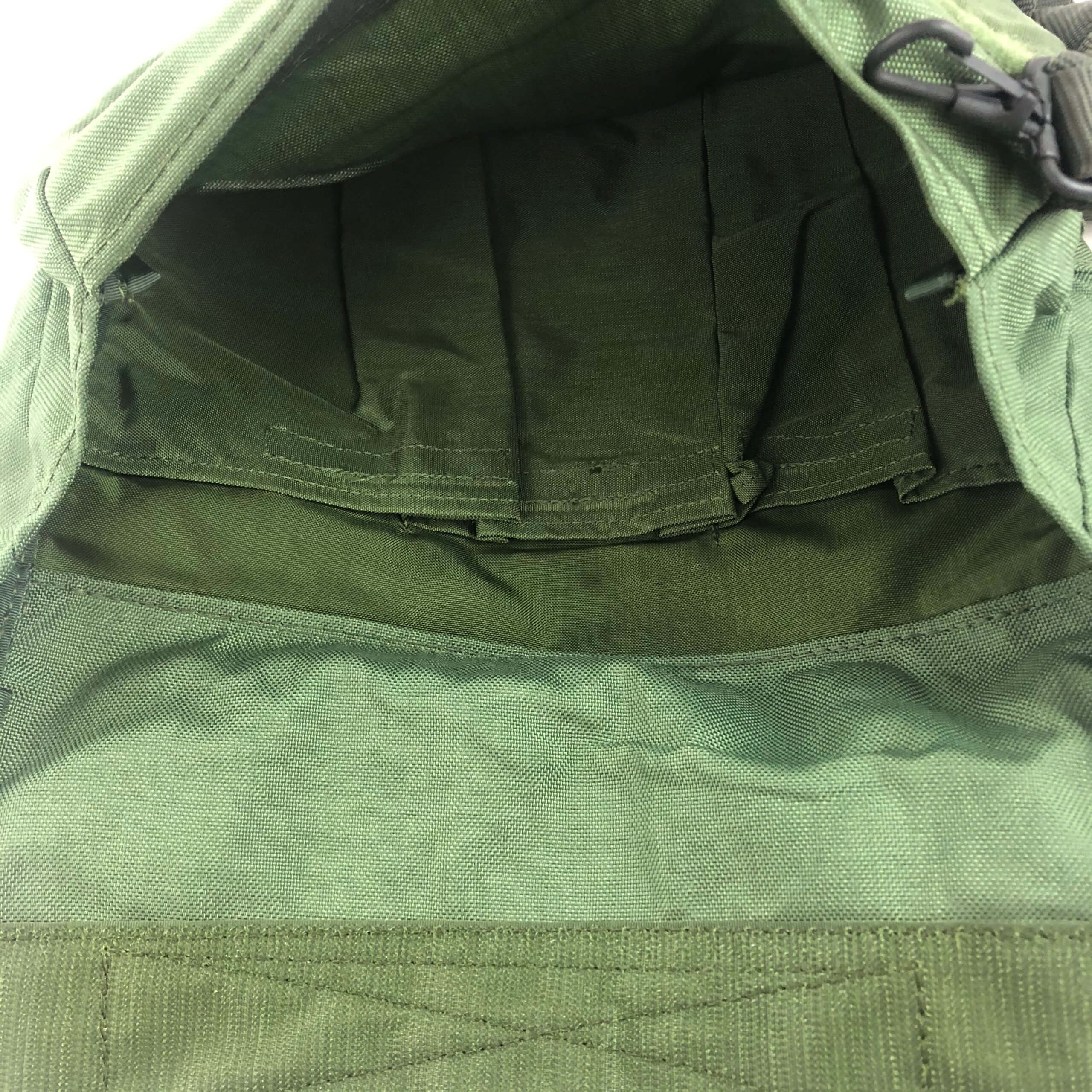 The main compartment has a hook and loop flap with multiple slots for accessories.